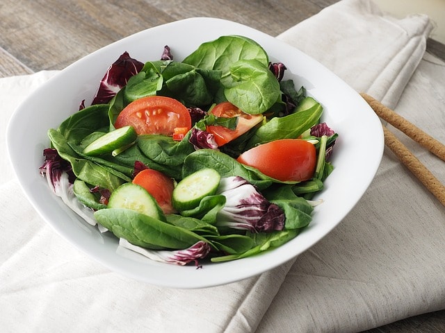 Dalade vegetarienne avec des tranches de tomate, de courgette, de chou et d'herbes. 