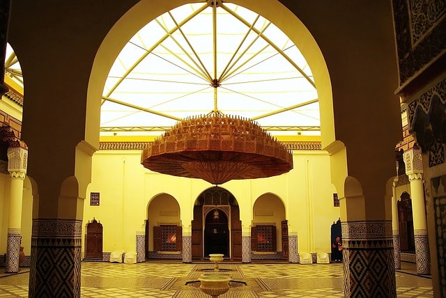 Patio d'une grande demeure orné d'un gigantesque lustre d'architecture typiquement marocaine à Marrakech.