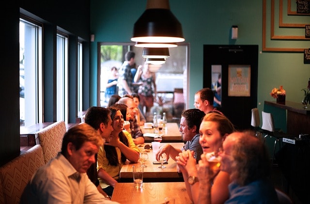 Personnes sirotant des verres tout en discutant autour de la table à Copenhague.