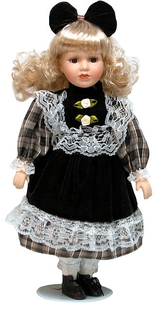 Petite poupée ancienne en robe noire.