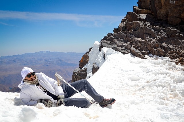 Homme assis sur la neige.