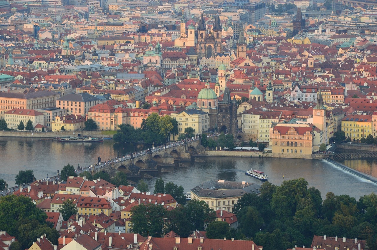 Un vol Prague pas cher avec Algofly illustré par la rivière Vltavala devant la ville au mille couleur vue du ciel.
