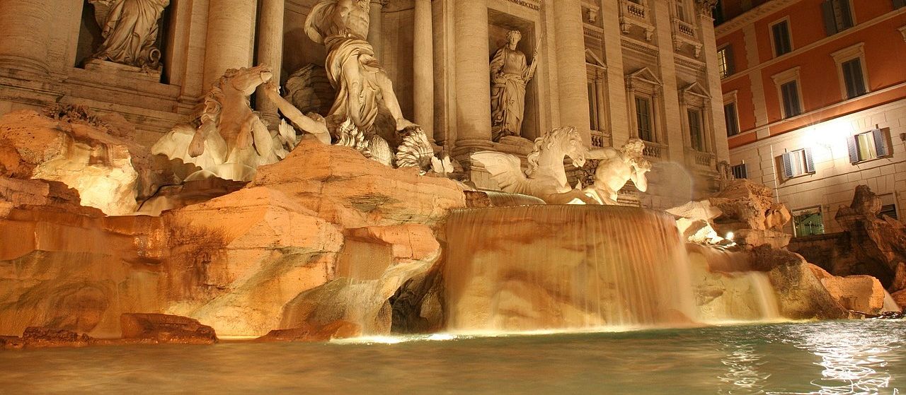 Un vol Rome pas cher avec Algofly illustré par la fontaine de Trevi illuminée de nuit.